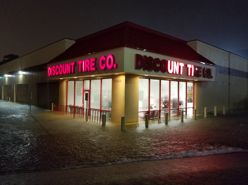 The flood waters rise outside a closed Discount Tire store in Port Arthur Texas